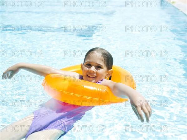 Girl (4-5) swimming in inflatable ring