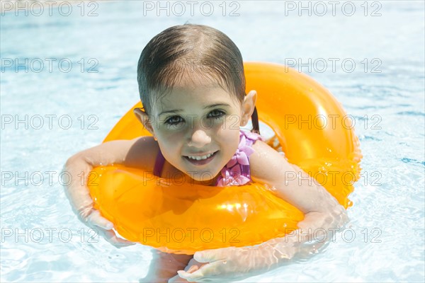 Portrait of girl (4-5) swimming in inflatable ring