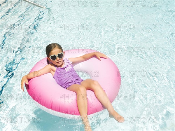 Girl (4-5) relaxing in inflatable ring