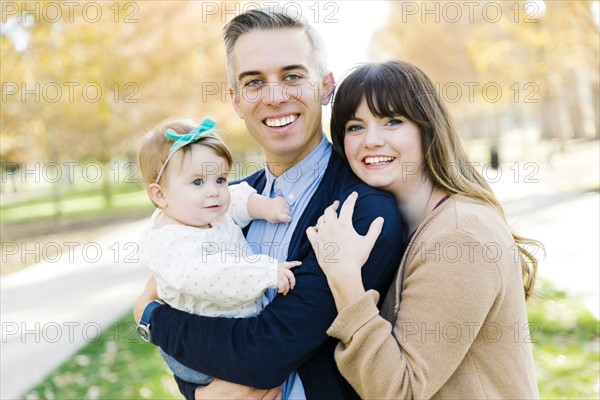 Parents with daughter (12-17 months) in park