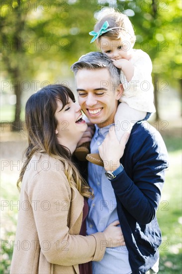 Parents with daughter (12-17 months) in park