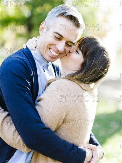 Woman kissing man