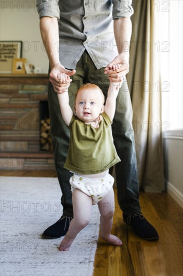 Father walking with daughter (12-17 months)