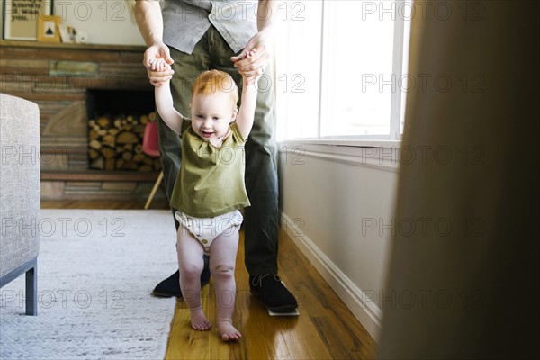 Father walking with daughter (12-17 months)