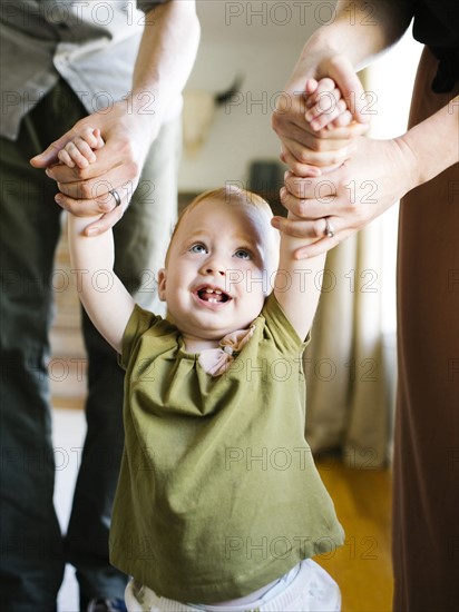 Girl (12-17 months) learning to walk