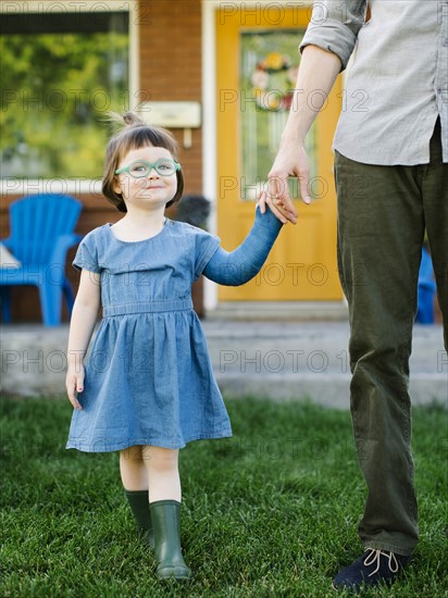 Daughter (2-3) walking with father