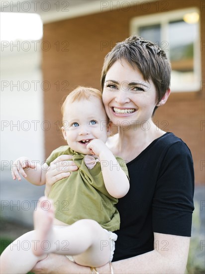 Mother holding daughter (12-17)