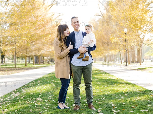 Parents with daughter (12-17 months) in park