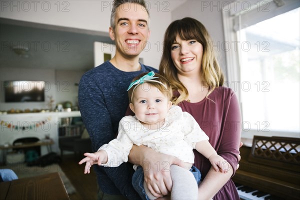 Parents with daughter (12-17 months) in living room