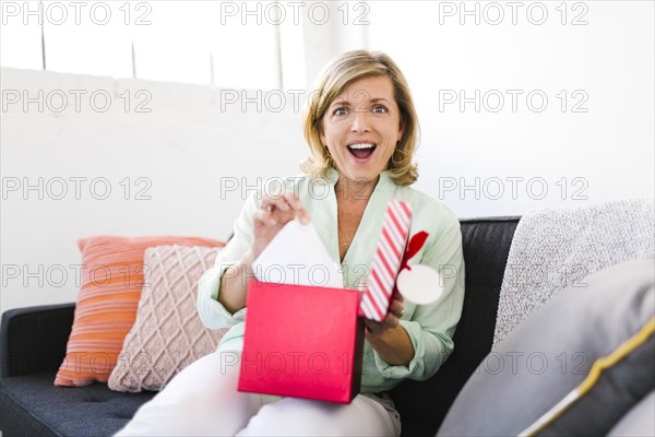 Portrait of surprised Mature woman with christmas gift