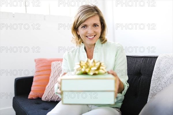 Portrait of Mature woman giving gift