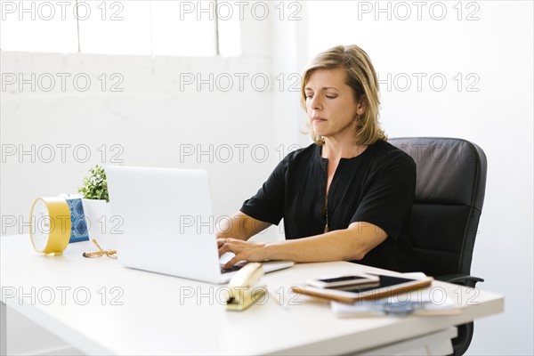 Mature woman working on laptop