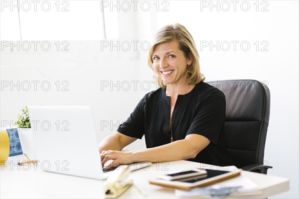 Portrait of Mature woman working on laptop