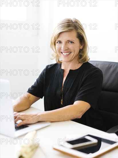 Portrait of Mature woman working on laptop