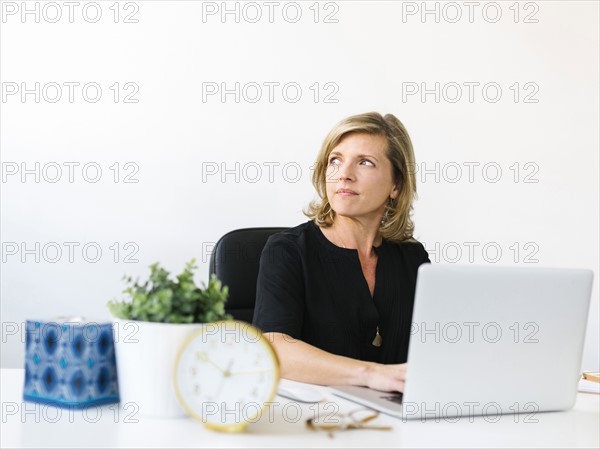 Pensive Mature woman in office
