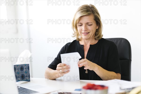 Mature woman opening letter