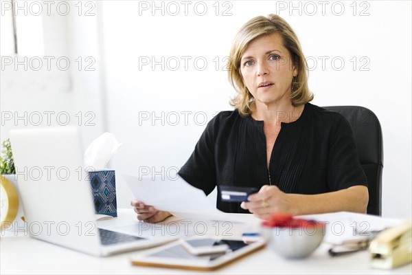 Portrait of Mature woman paying bills