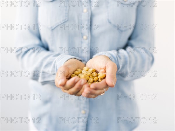 Woman holding handful of nuts