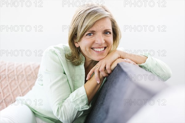 Portrait of woman sitting on sofa