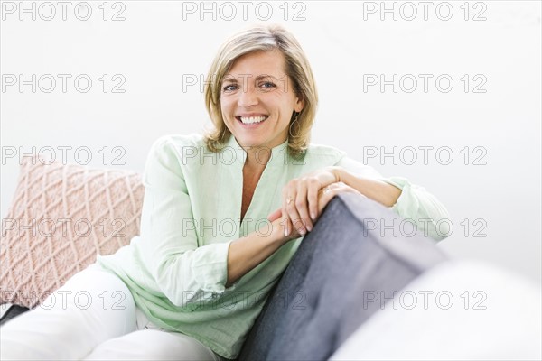 Portrait of woman sitting on sofa