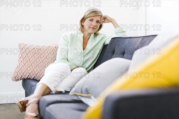 Portrait of woman sitting on sofa