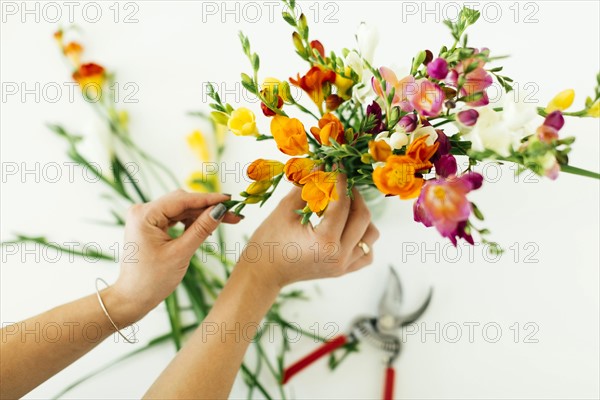 Woman putting flowers into jar