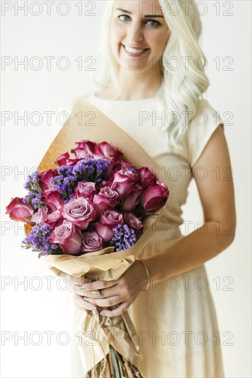 Woman holding bouquet with roses