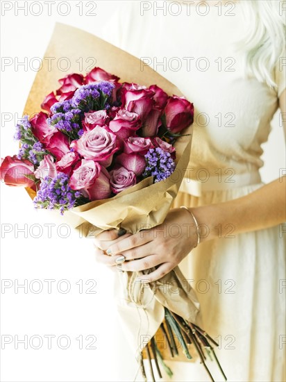 Woman holding bouquet with roses