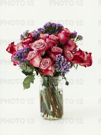 Jar with bouquet of red roses