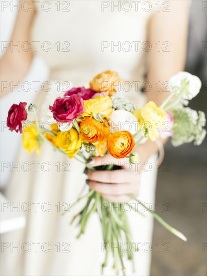 Woman holding bunch of flowers