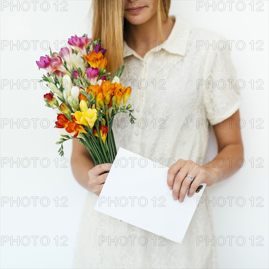 Woman holding bouquet and letter
