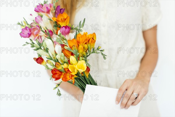 Woman holding bouquet and letter