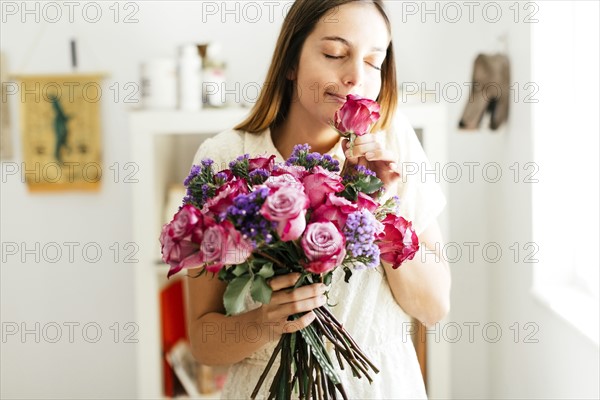 Woman smelling bouquet of roses