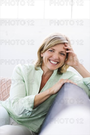 Portrait of woman sitting on sofa