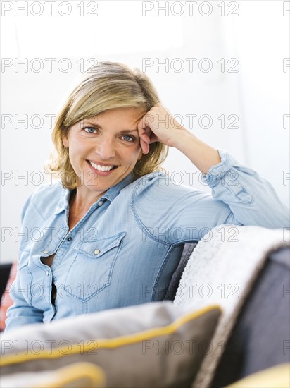 Portrait of woman sitting on sofa