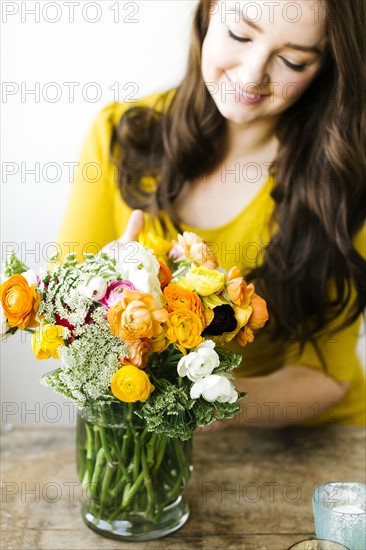 Woman touching bouquet of ranunculus