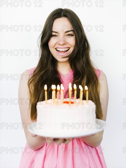 Portrait of woman holding birthday cake