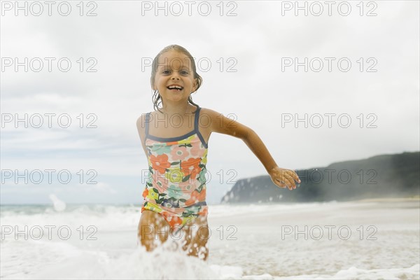 Girl (6-7) playing in sea