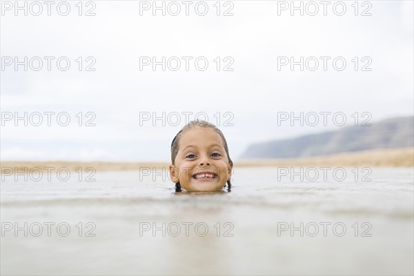Girl (6-7) swimming in sea