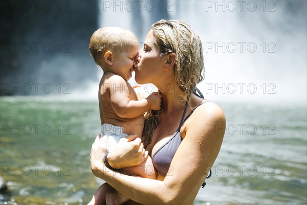 Mother kissing baby (18-23 months) with love