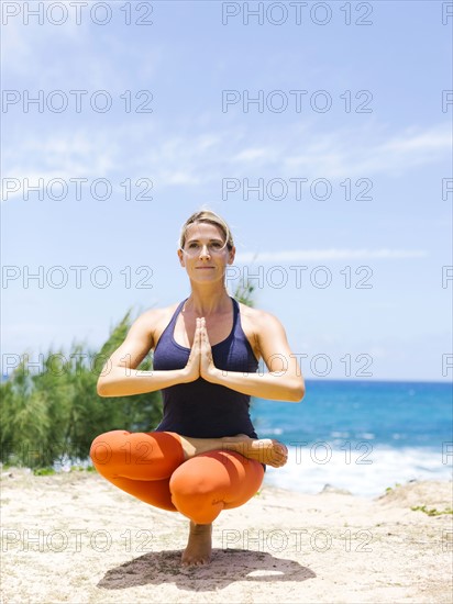 USA, Hawaii, Kauai, Woman doing yoga on sunny day