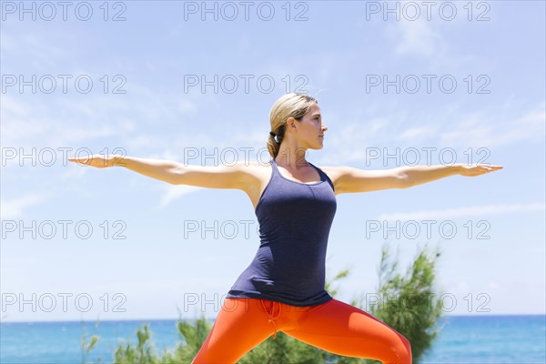 Woman stretching on sunny day