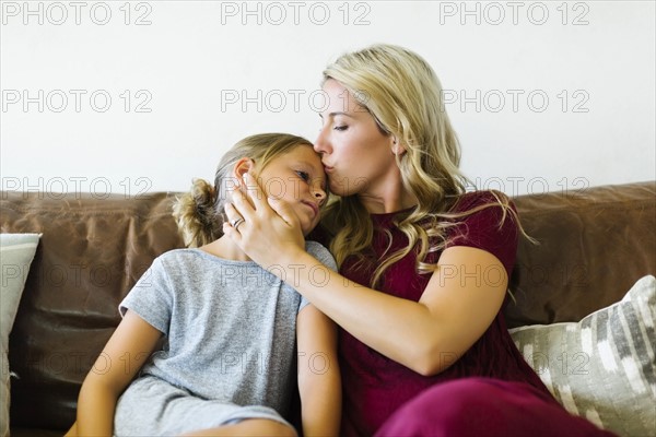 Woman kissing daughter (6-7) on forehead