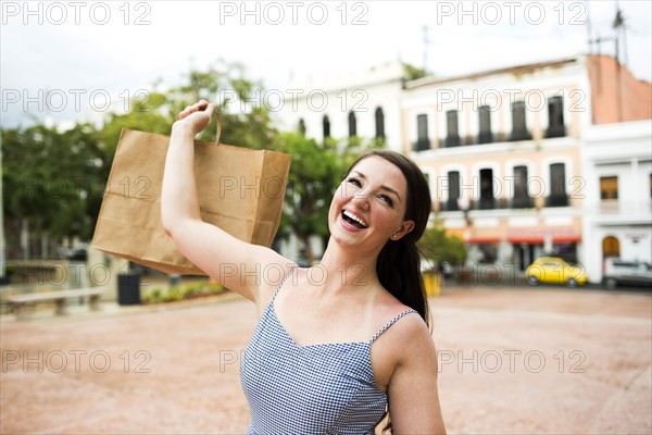 Puerto Rico, San Juan, Woman with shopping bag walking city streets