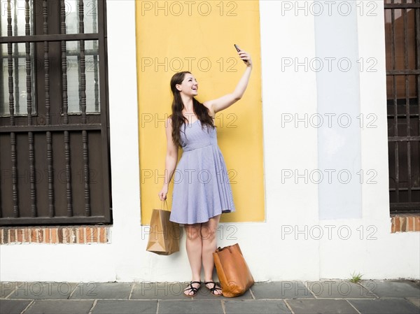 Puerto Rico, San Juan, Beautiful woman doing selfie on city street