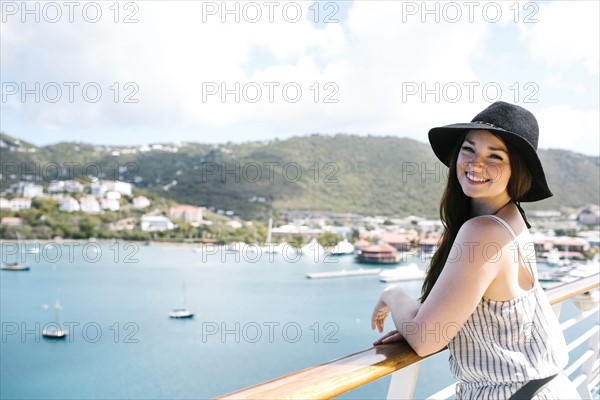 USA, Virgin Islands, Saint Thomas, Woman leaning against railing and looking at bay