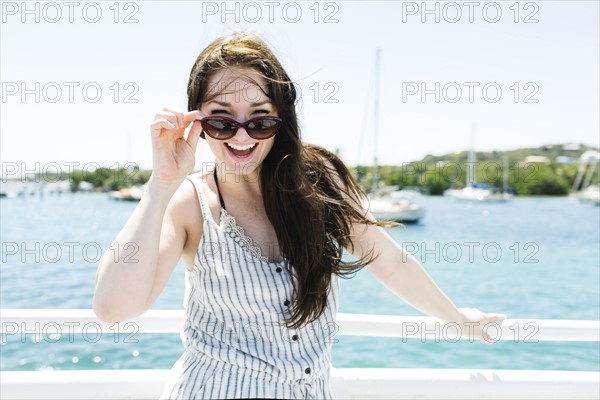 USA, Virgin Islands, Saint Thomas, Woman peeking over sunglasses