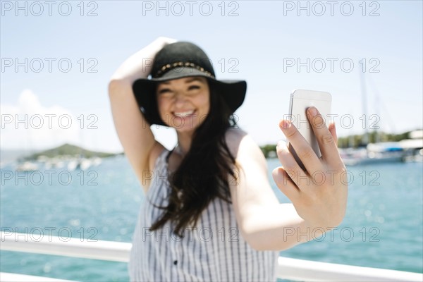 USA, Virgin Islands, Saint Thomas, Woman doing selfie with bay in background