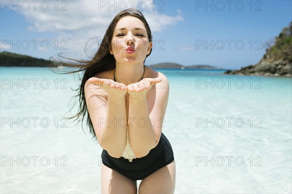 USA, Virgin Islands, Saint Thomas, Beautiful woman blowing kisses on beach