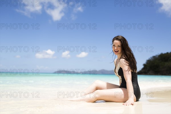 USA, Virgin Islands, Saint Thomas, Beautiful woman sitting on shore